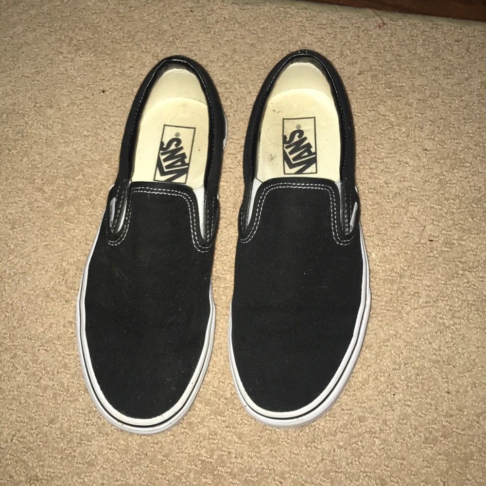 Black and white vans slip ons